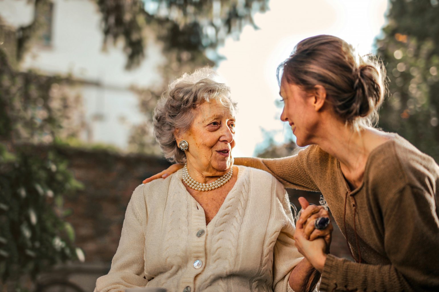 Elderly European grandmother Smiling and laughing with her daughter in the town square